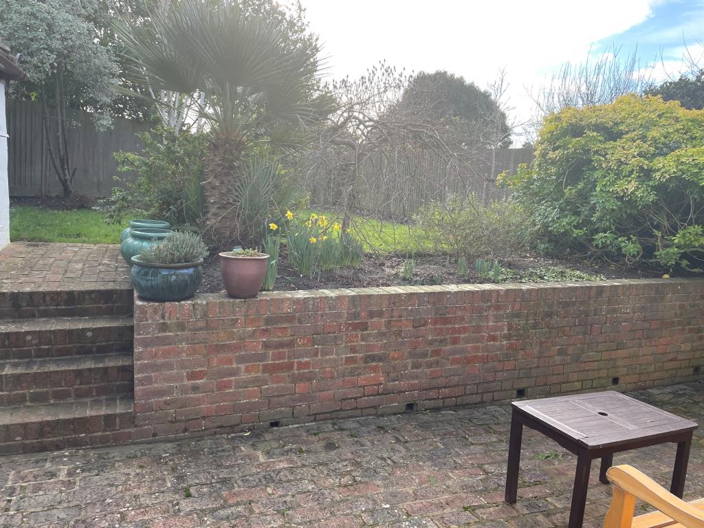 Lot: 101 - CHARACTER COTTAGE IN FAVOURED LOCATION - View of rear garden with brick patio and raised lawn